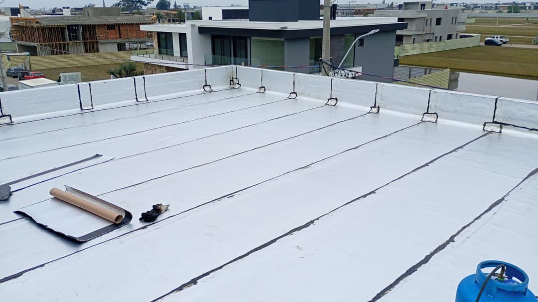 Aplicação de argamassa polimérica em uma laje para proteção contra umidade.